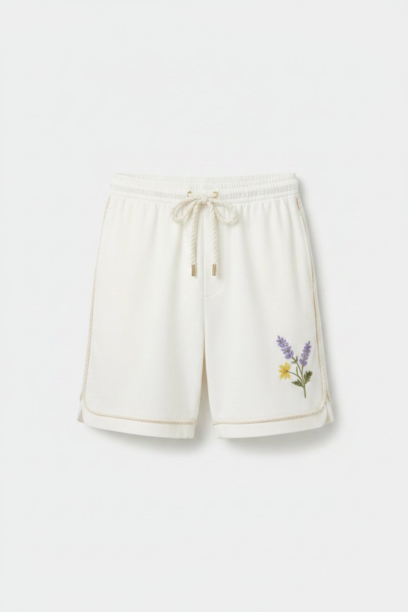 Two men wearing white t-shirts and pants on a plain background