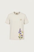 Man wearing a white t-shirt with floral design, product details, and brand information.