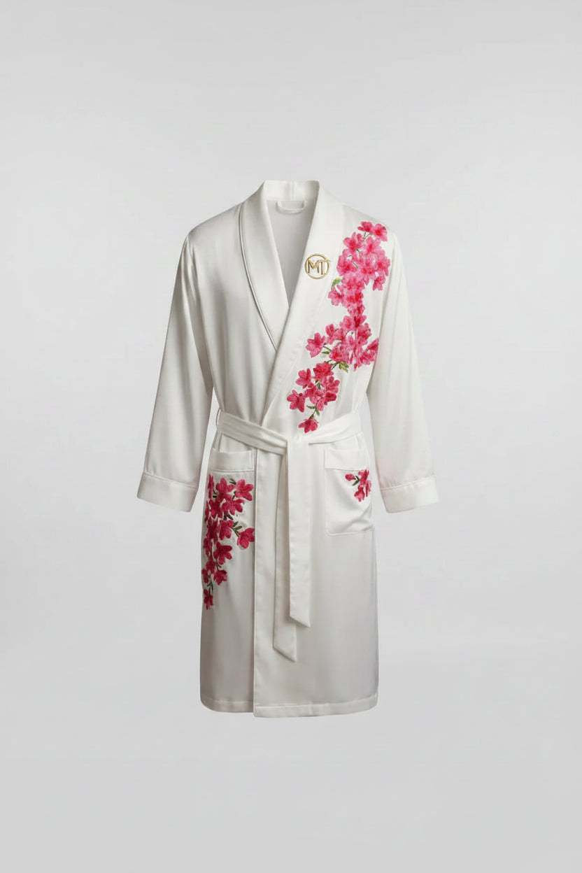 Three men wearing bathrobes with floral designs in a room with a city view.