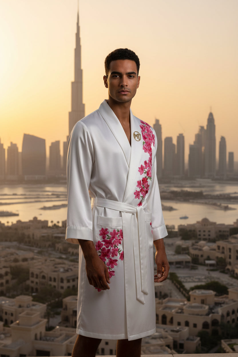 White robe with pink floral embroidery on a light gray background