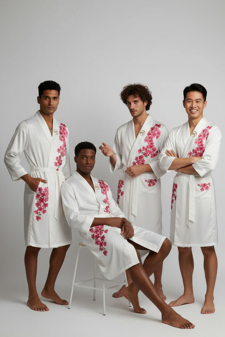 White robe with pink floral embroidery on a light gray background